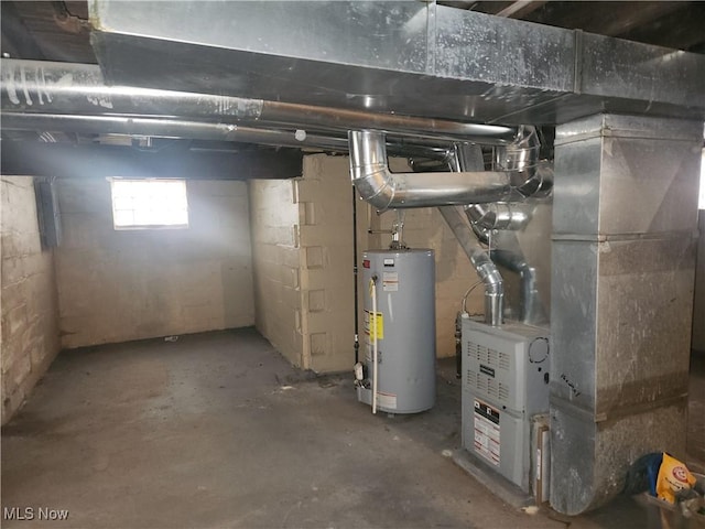 basement featuring heating unit and water heater