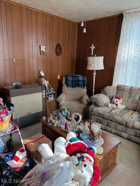 carpeted living room with wooden walls