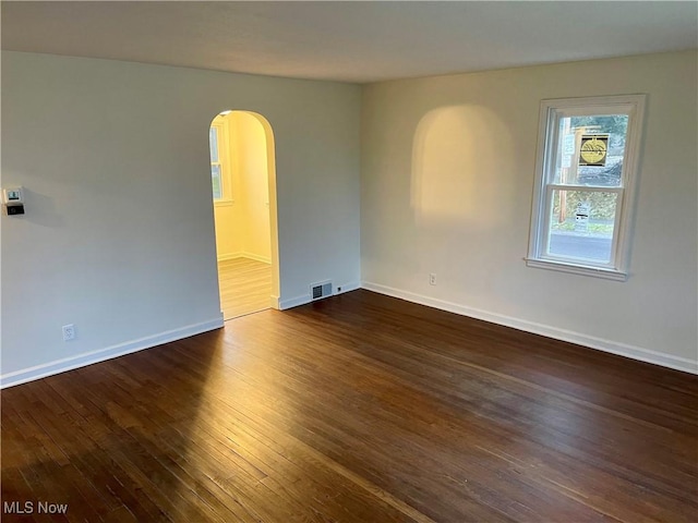 empty room with dark wood-type flooring