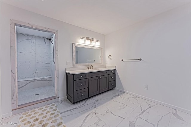 bathroom featuring a tile shower and vanity