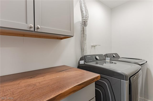 washroom with cabinets and independent washer and dryer