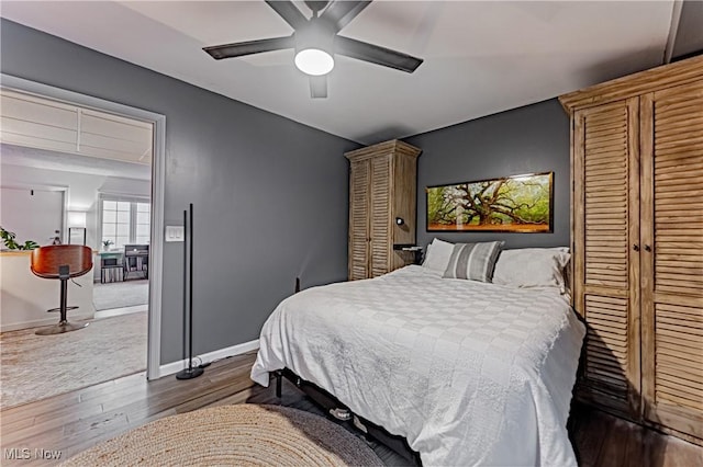 bedroom featuring ceiling fan and dark hardwood / wood-style floors