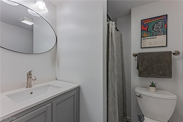 bathroom with walk in shower, vanity, and toilet