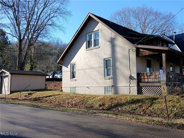 view of property exterior featuring an outbuilding and a garage