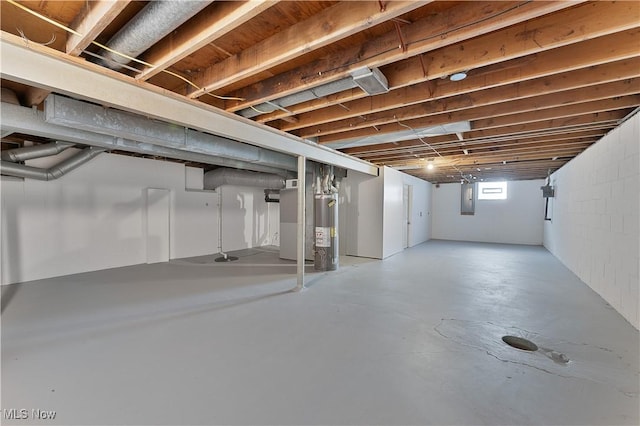 basement with electric panel, water heater, and heating unit