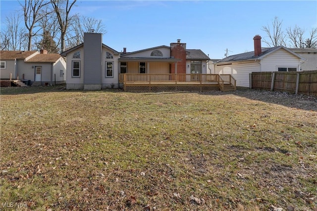 back of house featuring a yard and a wooden deck