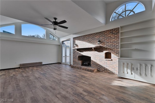 unfurnished living room featuring a fireplace, hardwood / wood-style flooring, ceiling fan, and a healthy amount of sunlight