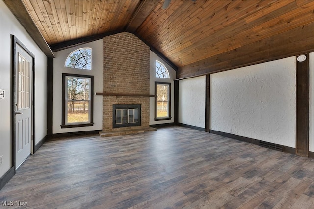 unfurnished living room featuring plenty of natural light, dark hardwood / wood-style floors, and a fireplace