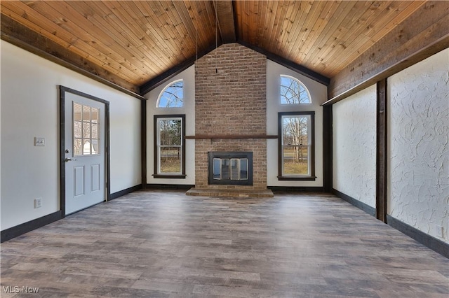 unfurnished living room with lofted ceiling with beams, dark hardwood / wood-style flooring, wooden ceiling, and a fireplace