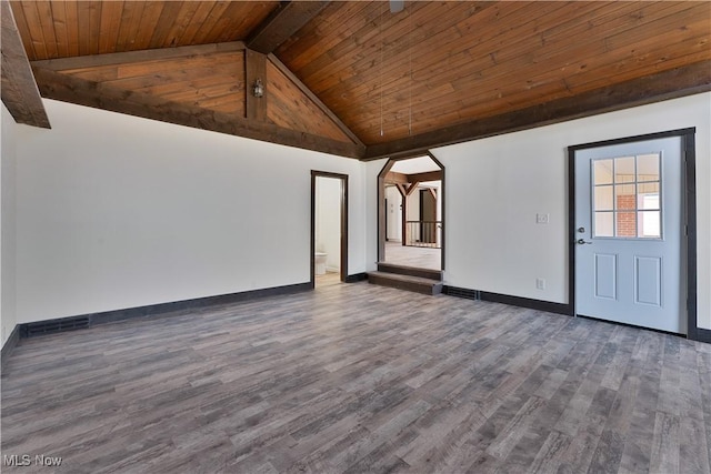 spare room with vaulted ceiling with beams, dark hardwood / wood-style floors, and wood ceiling