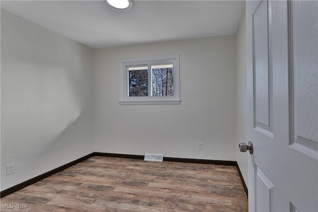 empty room featuring wood-type flooring