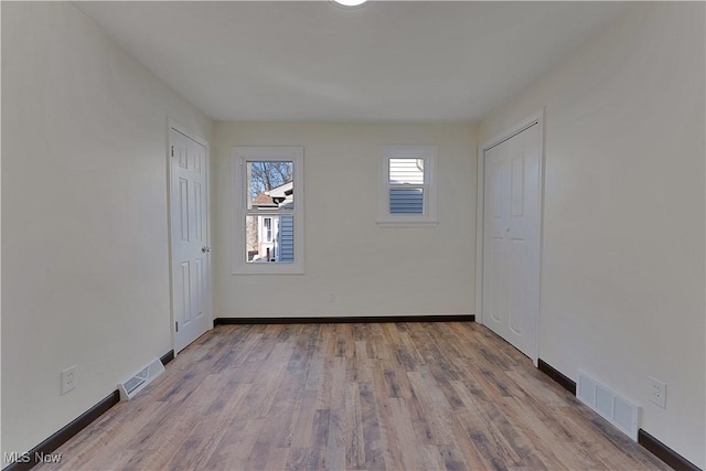 unfurnished room with light hardwood / wood-style flooring