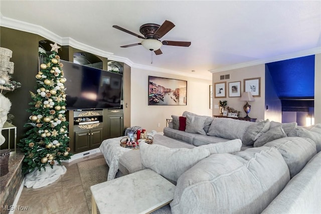 living room featuring tile patterned floors, ceiling fan, and ornamental molding