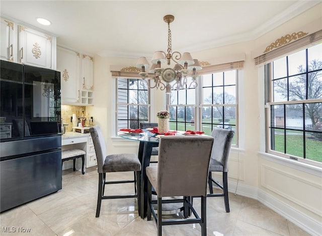 dining area featuring a notable chandelier and ornamental molding