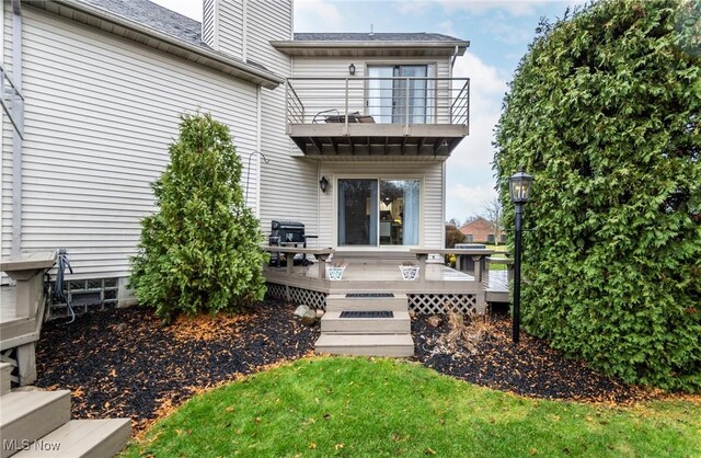 doorway to property with a balcony and a wooden deck