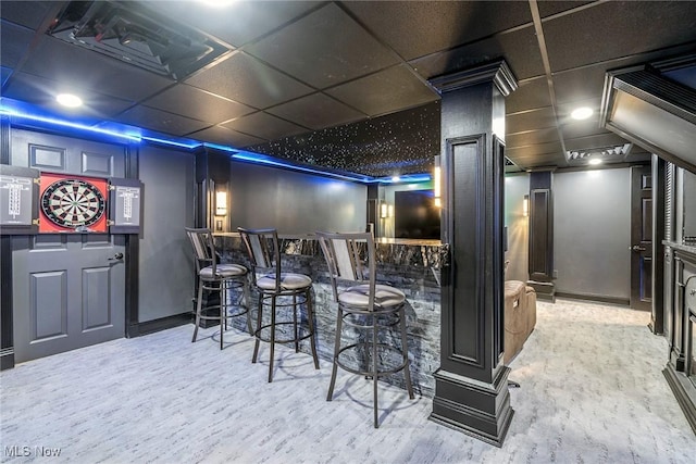 home theater featuring light hardwood / wood-style floors and bar