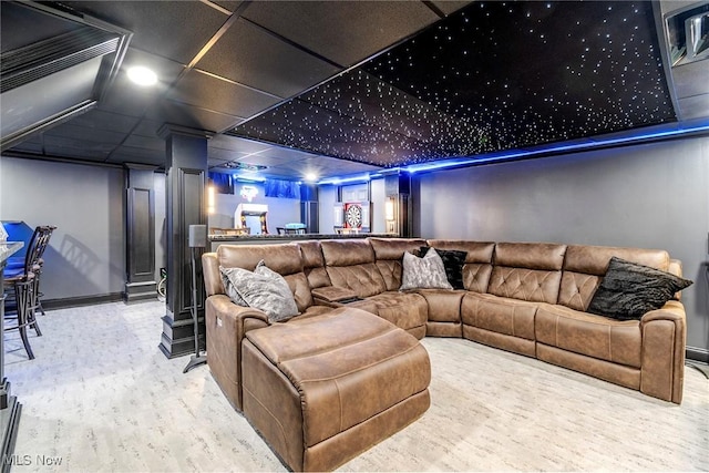 home theater with a bar, baseboards, and a paneled ceiling