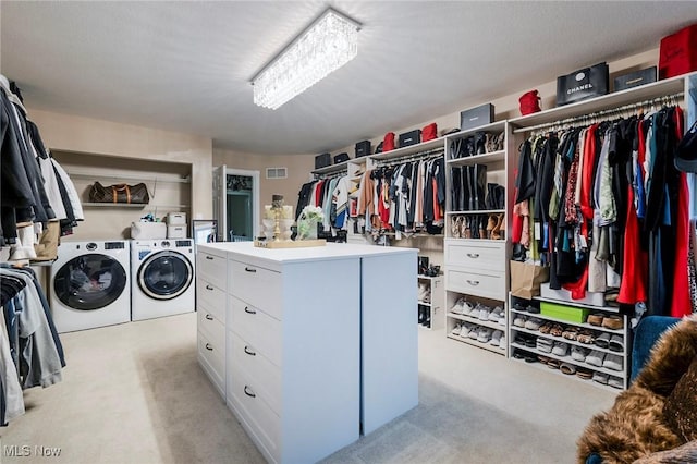 walk in closet with visible vents and washer and clothes dryer