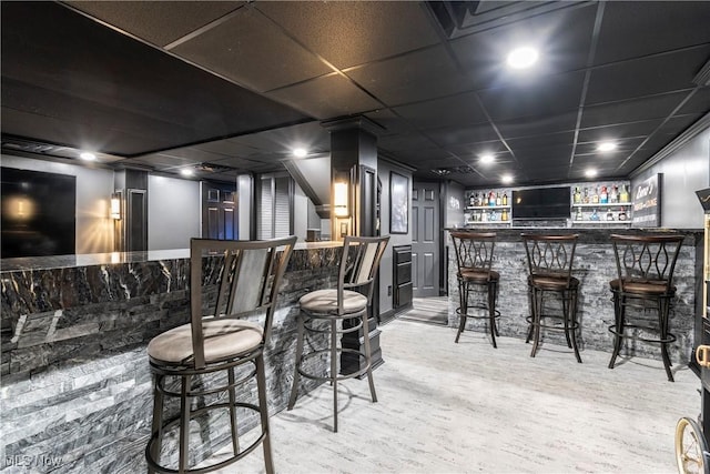 bar with a drop ceiling and bar area