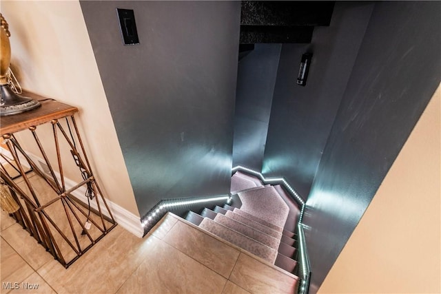 stairway with tile patterned flooring and baseboards