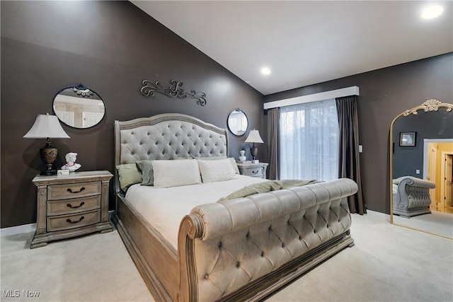 bedroom with vaulted ceiling and carpet