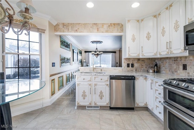 kitchen with crown molding, a notable chandelier, visible vents, appliances with stainless steel finishes, and white cabinetry