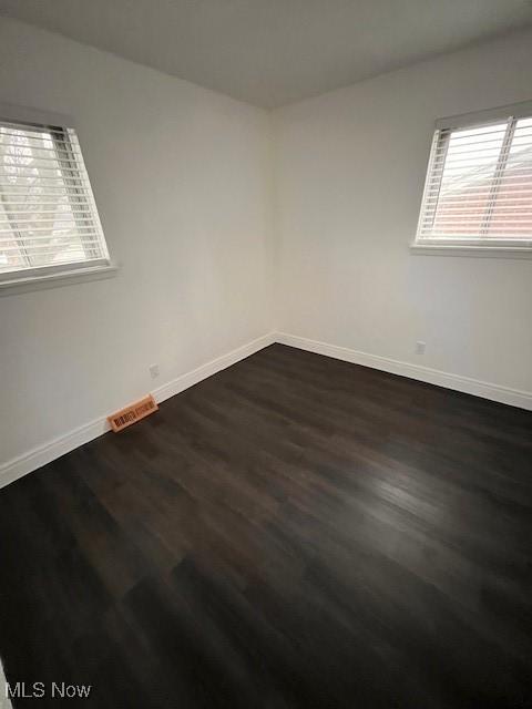 spare room featuring dark hardwood / wood-style floors