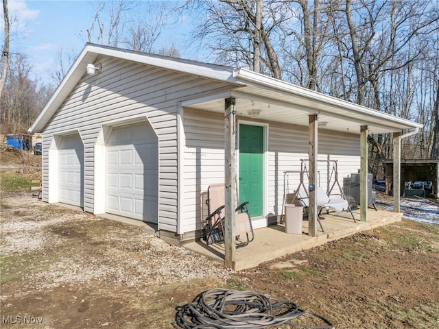 exterior space featuring central AC, an outdoor structure, and a garage