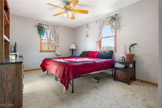 carpeted bedroom with multiple windows and ceiling fan