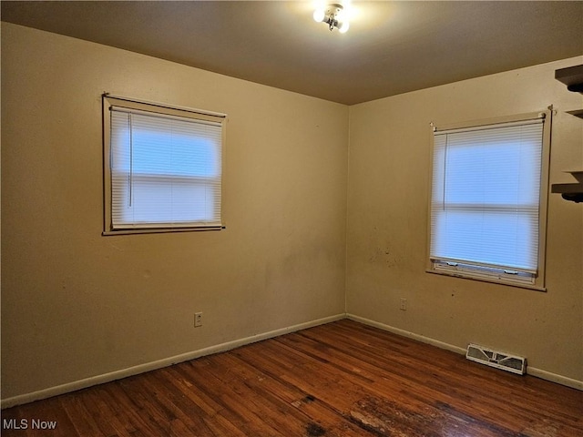 spare room featuring dark wood-type flooring