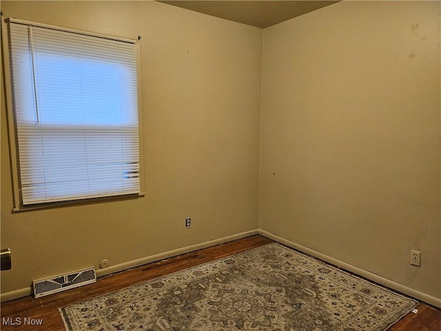 unfurnished room featuring dark hardwood / wood-style floors