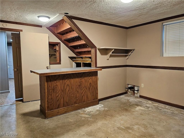 interior space featuring crown molding, a textured ceiling, and concrete floors