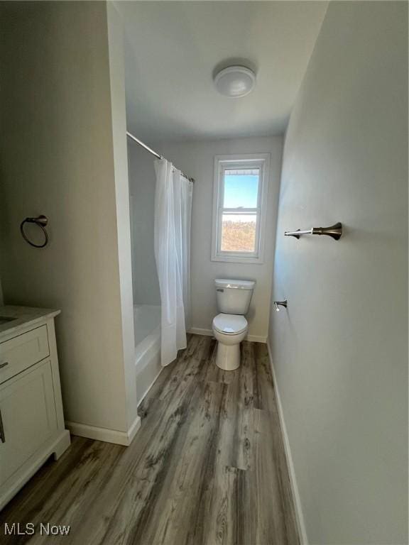 full bathroom with shower / bathtub combination with curtain, vanity, toilet, and wood-type flooring