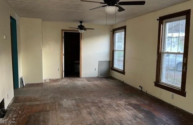 unfurnished room with ceiling fan and dark hardwood / wood-style floors