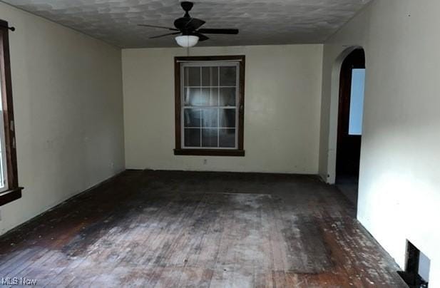 spare room featuring ceiling fan, hardwood / wood-style floors, and a textured ceiling