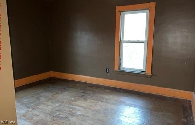 spare room with wood-type flooring