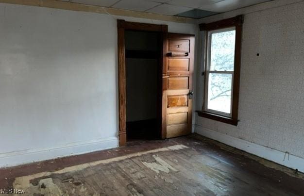 unfurnished bedroom with a paneled ceiling and hardwood / wood-style floors