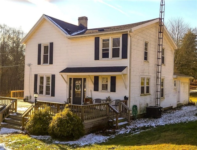 view of front of property with a chimney and a wooden deck