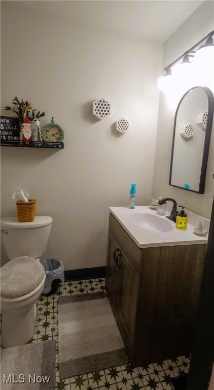 half bathroom featuring toilet and vanity