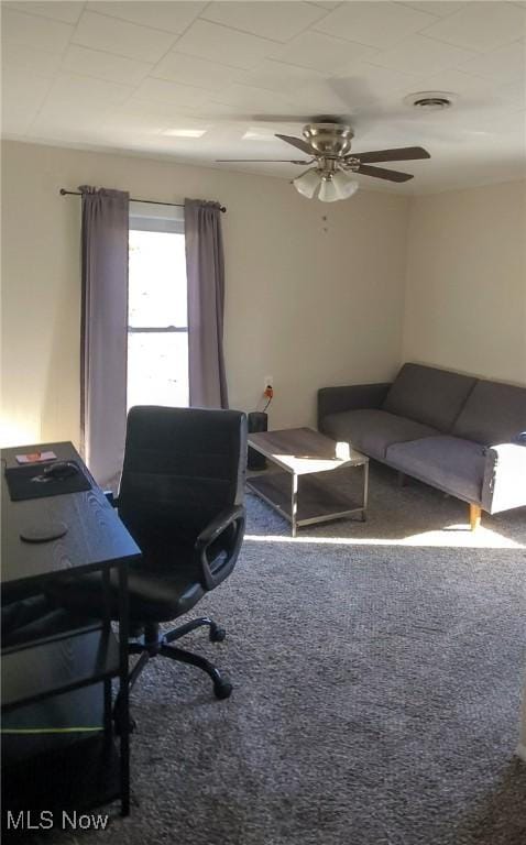 carpeted home office featuring visible vents and a ceiling fan