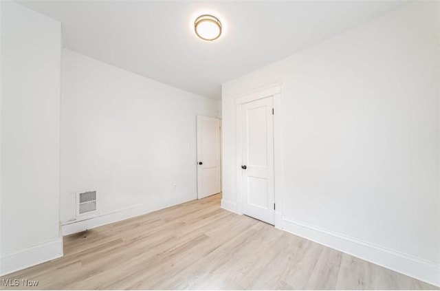 spare room featuring light hardwood / wood-style floors