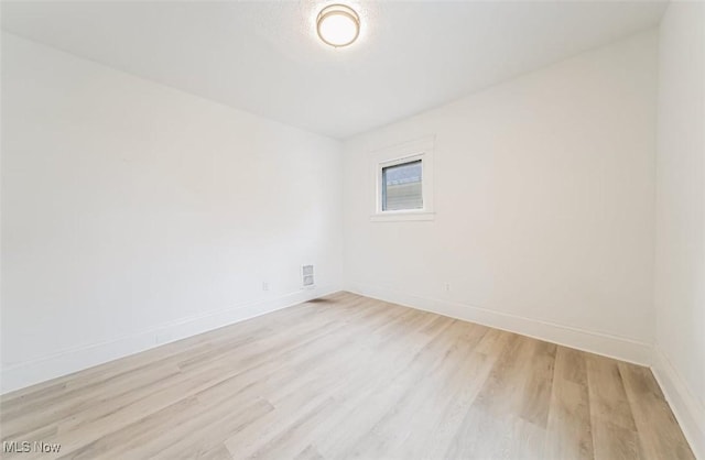 unfurnished room with light wood-type flooring