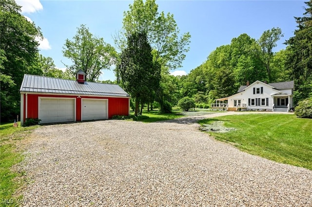 exterior space featuring an outbuilding, a garage, and a front lawn