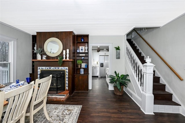 living room with dark hardwood / wood-style floors and a brick fireplace