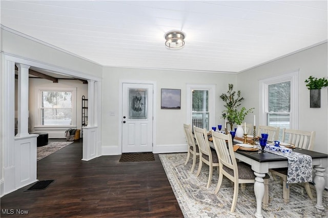 dining space featuring dark hardwood / wood-style floors and ornamental molding