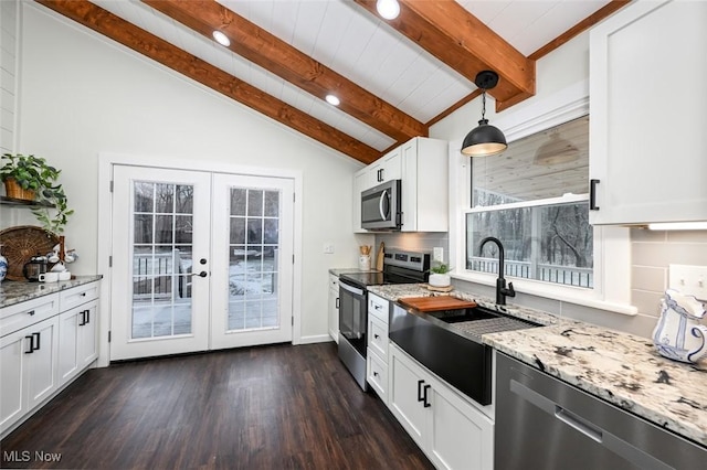 kitchen featuring french doors, sink, stainless steel appliances, decorative light fixtures, and white cabinets