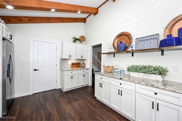 kitchen featuring white cabinets, stainless steel refrigerator with ice dispenser, dark wood-type flooring, and beam ceiling