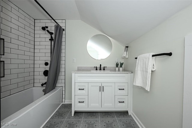 bathroom with tile patterned floors, vanity, shower / bath combo with shower curtain, and vaulted ceiling