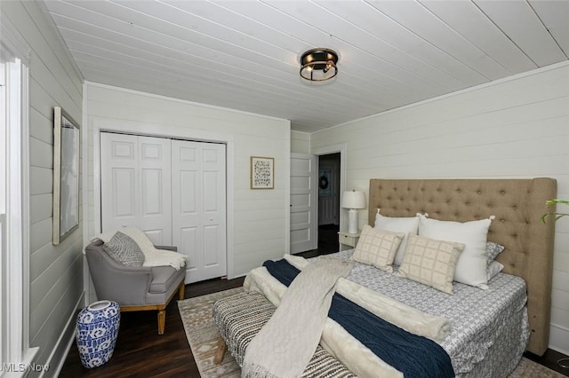 bedroom with dark hardwood / wood-style flooring and a closet