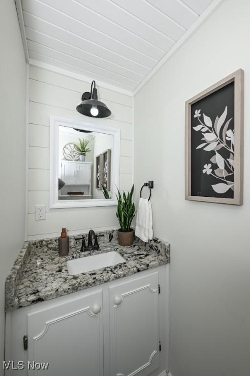 bathroom featuring crown molding and vanity